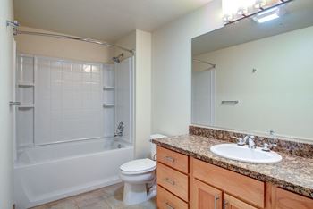 a bathroom with a toilet sink and bathtub  at 128 on State, Washington